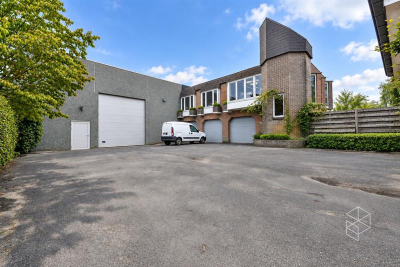 Grote loods met burelen, 3 garages, ruime buitenruimte en woning te koop in Hertsberge